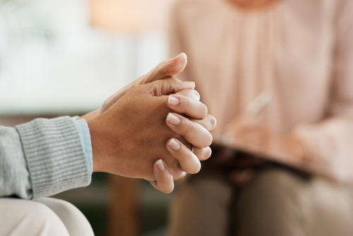 Therapy, mental health or nervous woman hands with psychologist in consultation office for mind