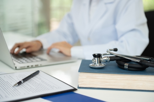 stethoscope on medical textbook with doctor are learning continuing medical education