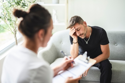 A Man with psychologist theraphy social problems concept drug addiction talk to a psychological woman